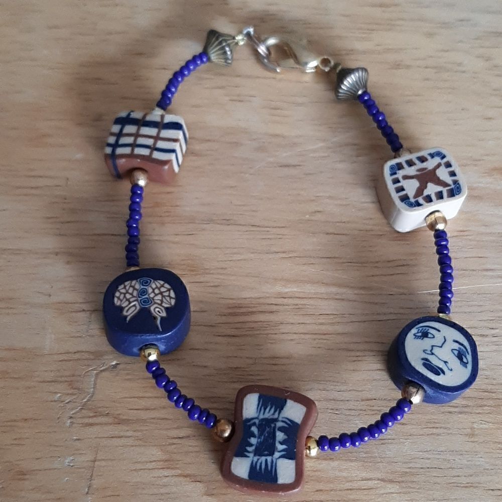 Vintage fun bracelet with blue beads and unique charms.
